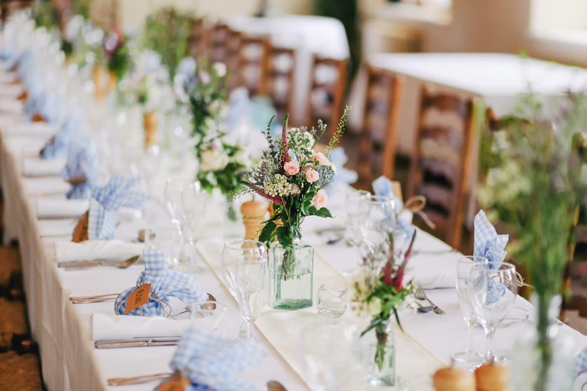 Elegant wedding reception table styled with florals and warm natural light
